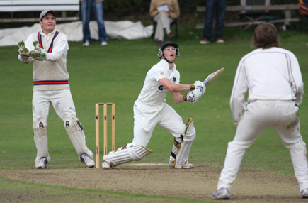 CSNI's Michael Heaney hits out watched by Waringstown wicketkeeper Johnny Bushe (C) John Boomer CricketEurope